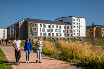 Three students walking from there campus accommodation